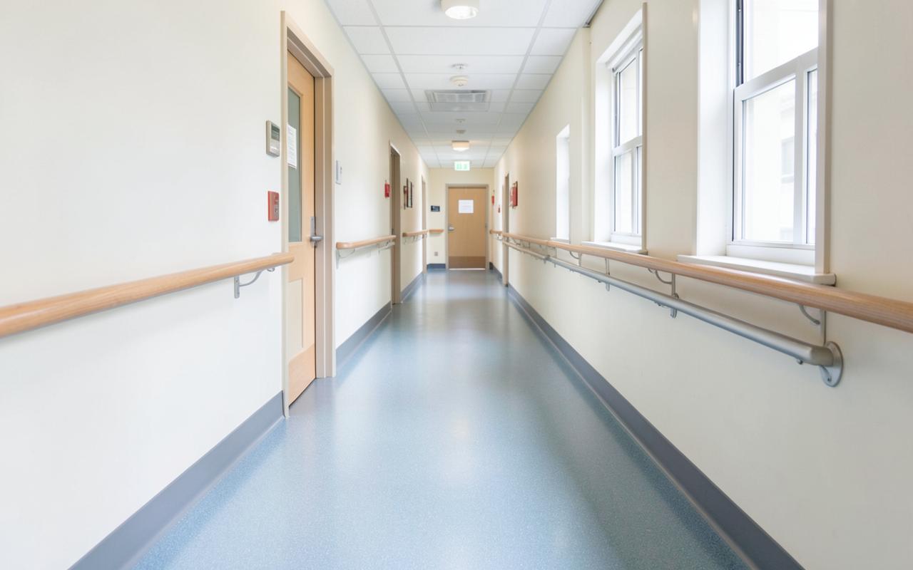 Aged care corridor with vinyl safety flooring and timber handrails